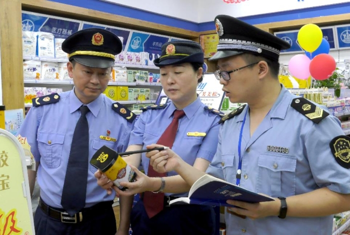 圖為該局執(zhí)法人員在一家藥店檢查藥品保質(zhì)期。