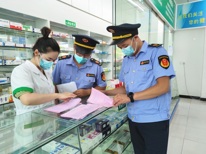 圖為監(jiān)管人員在一家藥店檢查。