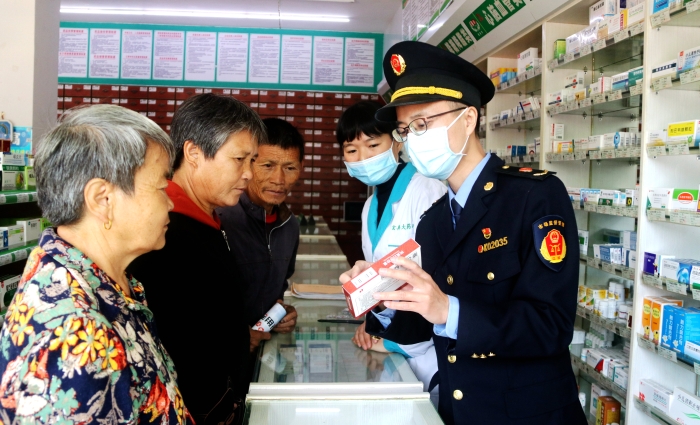 圖為11月15日工作人員在一家藥店向群眾講解安全用藥知識(shí)