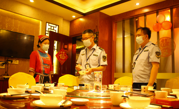 圖為鐘山縣市場(chǎng)監(jiān)管局執(zhí)法人員在一家飯店檢查餐飲具清洗消毒情況。