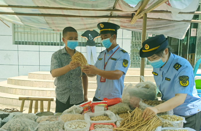 圖為8月3日，該局執(zhí)法人員在一處鄉(xiāng)鎮(zhèn)集市中藥材攤位檢查在售藥材質(zhì)量。