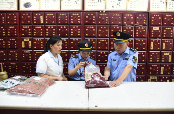 圖為該局執(zhí)法人員在一家藥品零售企業(yè)檢查在售中藥飲片質(zhì)量。