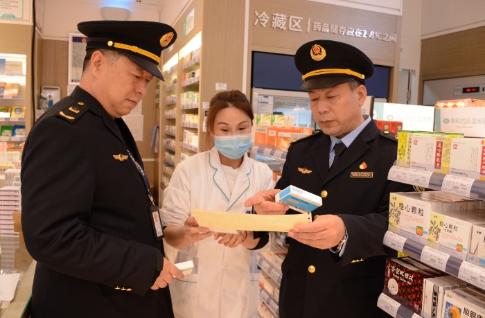 圖為執(zhí)法人員在一家藥品經(jīng)營企業(yè)檢查抗病毒藥品的購進(jìn)情況。